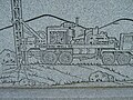 Detail of artwork on the gravestone of a well driller.