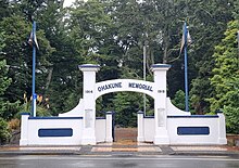 photo of large concrete memorial gate with arch.