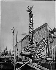 Totem poles in front of homes in Alert Bay in the 1900s