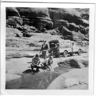 Washing dishes in a Palm Valley waterhole, c1955