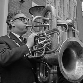 Nederlands Studenten Orkest in de Ruïnekerk (Bergen). Burgemeester L.J. de Ruiter speelt op een blaasinstrument (1967)