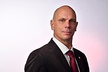 A portrait photo of Marcus Albert Reid wearing a suit.