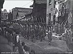 Troops from the 34th Brigade march through Saijo in 1946