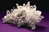 A cluster of clear, colorless quartz crystals.