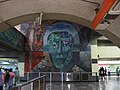 Mural of stone mask in the Line 1 section of Metro Tacubaya, at entrance to line leading towards Pantitlán.