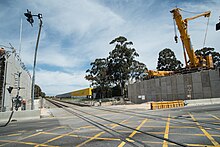 A level crossing with a bridge being built next to it