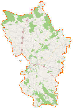 Mapa konturowa powiatu kaliskiego, blisko centrum na prawo znajduje się punkt z opisem „Warszew”