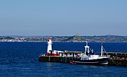 View of Newlyn Harbour with the lighthouse and Tidal Observatory to its right