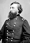 Black and white photo shows a heavily bearded man wearing a dark military uniform with the one star of a brigadier general on his shoulder tab.