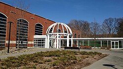 A two-story brick building with a steel half-dome vestibule outside its front entrance