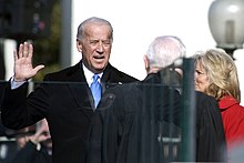 Photo of Biden raising his right hand, reciting the Oath