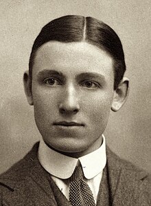 portrait photograph of a young man in a tweed suit and tie