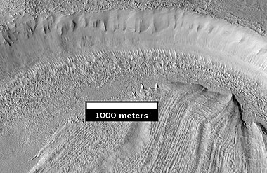 Concentric Crater Fill Close-up of near the top of previous image, as seen by HiRISE. The surface debris covers water ice.