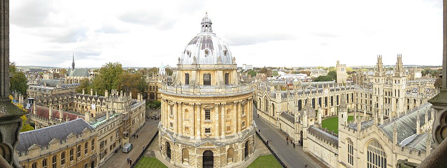 A view from the tower of the University Church of St Mary the Virgin: to the left, Brasenose College, with the spire of the chapel of Exeter College behind; in the centre, the Radcliffe Camera; to the right, the belltower of New College and then All Souls College with the tower of St Peter-in-the-East (now the library of St Edmund Hall) behind