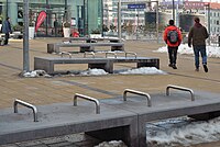 Benches with metal pipes to prevent lying down at a train station in Vienna.