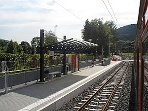 Side platform with canopy-covered section