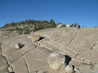 Glacial erratics dot the granite slopes immediately south of the vista point.