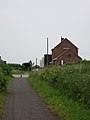 Zicht op oud stationsgebouw vanop Vrijbosroute