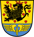 Gemeinde Neuenmarkt Über blauem Schildfuß, darin ein goldenes Flügelrad, in mit roten Herzen bestreutem goldenen Feld ein rot gekrönter, rot bewehrter und rot gezungter schwarzer Löwenrumpf.