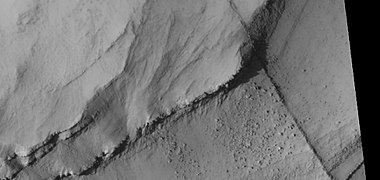 Close view of layers, as seen by HiRISE under HiWish program. A ridge cuts across the layers at a right angle.