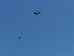 A helicopter flying to the Deer Ridge Fire