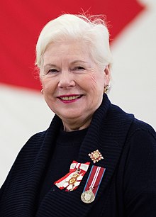 Dowdeswell wearing dark blue smiling towards the camera