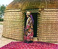 Uzbek woman at the entrance to a yurt, in Turkestan