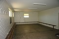 Inside the change rooms. The seating is the original jarrah benches, besides a few coats of paint and the installation of the florescent lights the change rooms are unaltered from the 1962 Empire Games