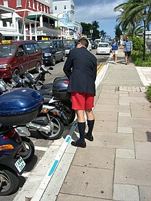 A businessman wearing Bermuda shorts