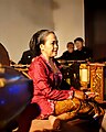 A sindhen wearing kebaya in Javanese singing performance