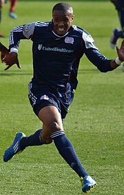 A soccer player is running.