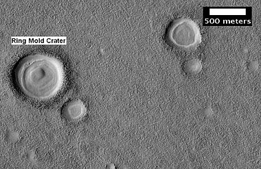 Possible ring mold crater, as seen by HiRISE under the HiWish program. Crater shape is due to impact into ice.