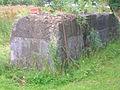 Concrete plinth for heavy machinery. A quarry drill is leaning against it.