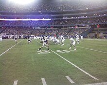 Two football teams on the field in position prior to the play