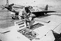 Mechanics reloading guns on P-51 "Mustang".