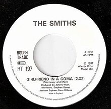 Close up of a vinyl disk containing the single "Girlfriend in a Coma" by The Smiths.