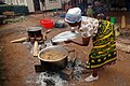 Image 26A Tanzanian woman cooks Pilau rice dish wearing traditional Kanga. (from Tanzania)