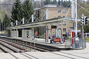 Canopy-covered station platform next to double track