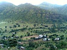 A small village with mountains in the background