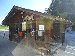 Wooden shelter with a sign, departure board and waiting room