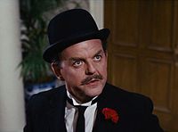 David Tomlinson as the London banker Mr. Banks in Mary Poppins. Set in early-20th-century London, bowlers were associated with City gents.[2]