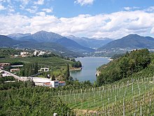 A view of Lake of St. Justina from above against a backdrop of mountains