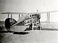 Brandon-Cremer self taken image alongside Kingsford-Smiths biplane at Wallal