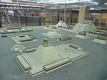 A scale model of several Aztec pyramids and buildings.