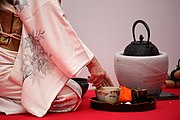 A hostess prepares matcha during a Japanese outdoor tea ceremony