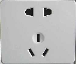 Chinese dual socket accepting both unearthed 2-pin (upper) and earthed 3-pin (lower) plugs