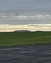 T-Shaped object situated above the airfield runway.