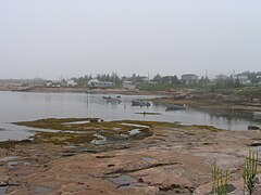 Piashti River, boats at anchor, sheds and wooden boardwalks