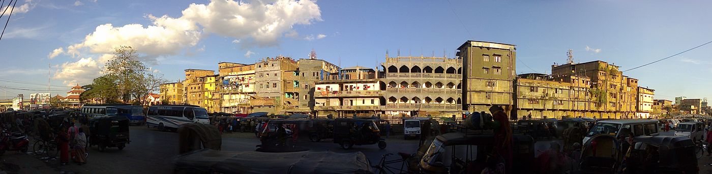 Old urban buildings, buses and cars