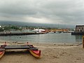 The small beach is protected by the pier.